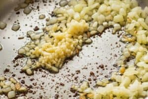 aromatics in a pan being cooked