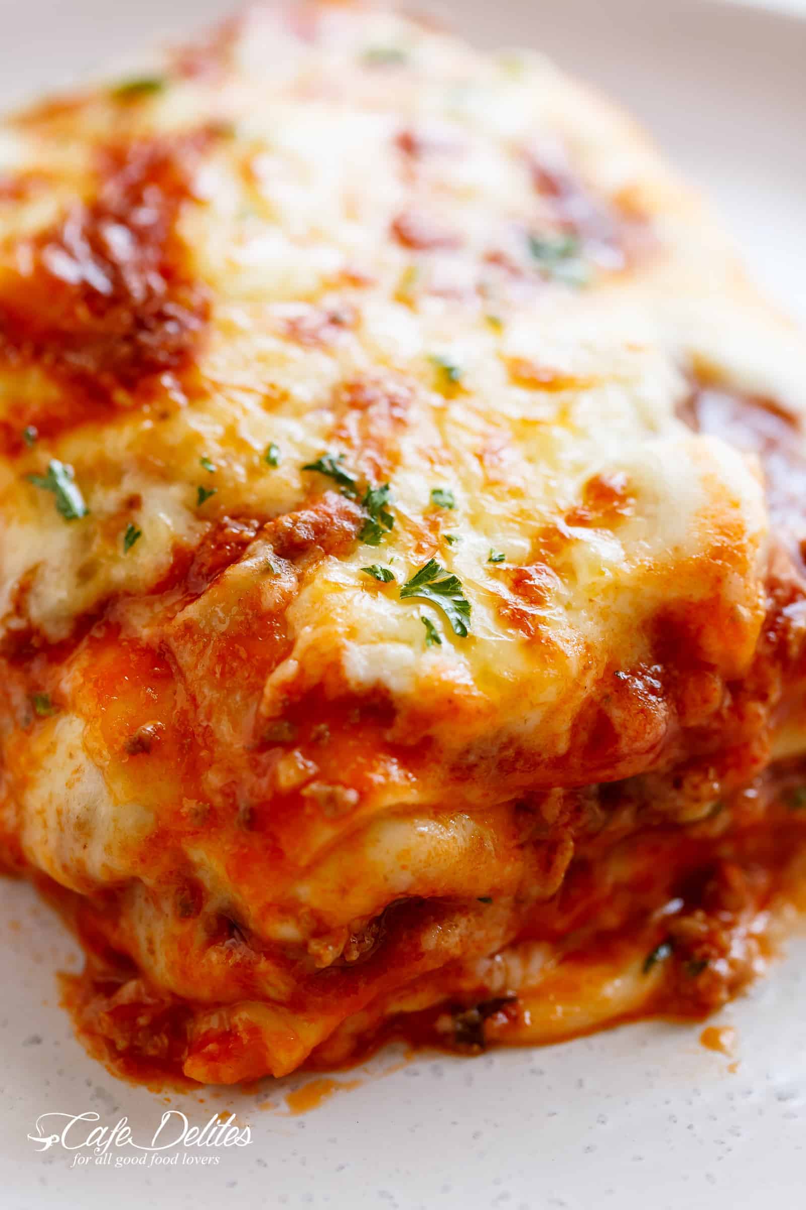 Image of lasagna being served on a plate.
