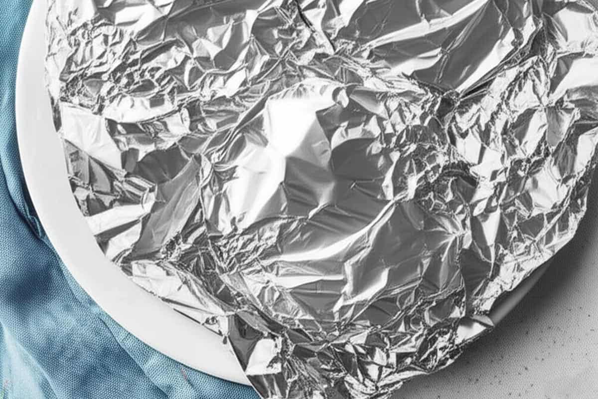 Plate covered loosely with foil.