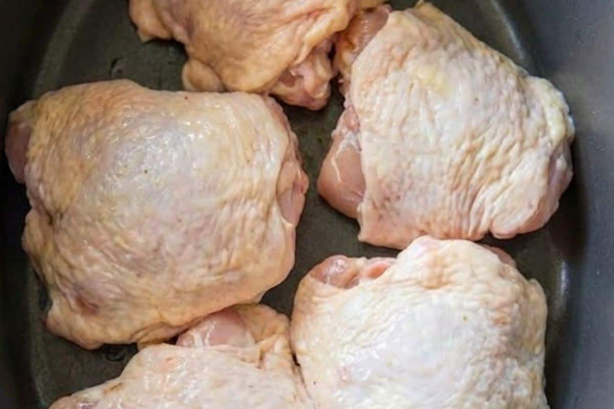 Place the chicken thighs skin side up in the slow cooker