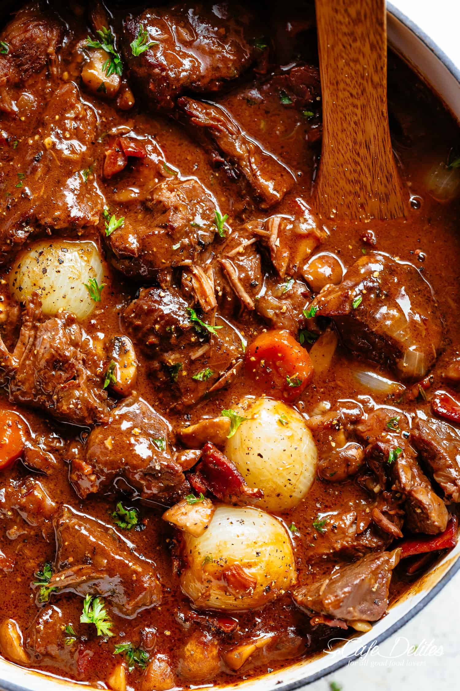 Tender fall apart chunks of beef simmered in a rich red wine gravy makes Julia Child's Beef Bourguignon an incredible family dinner. Slow Cooker, Instant Pot/Pressure Cooker, Stove Top and the traditional Oven method included! Easy to make, every step is worth it | cafedelites.com