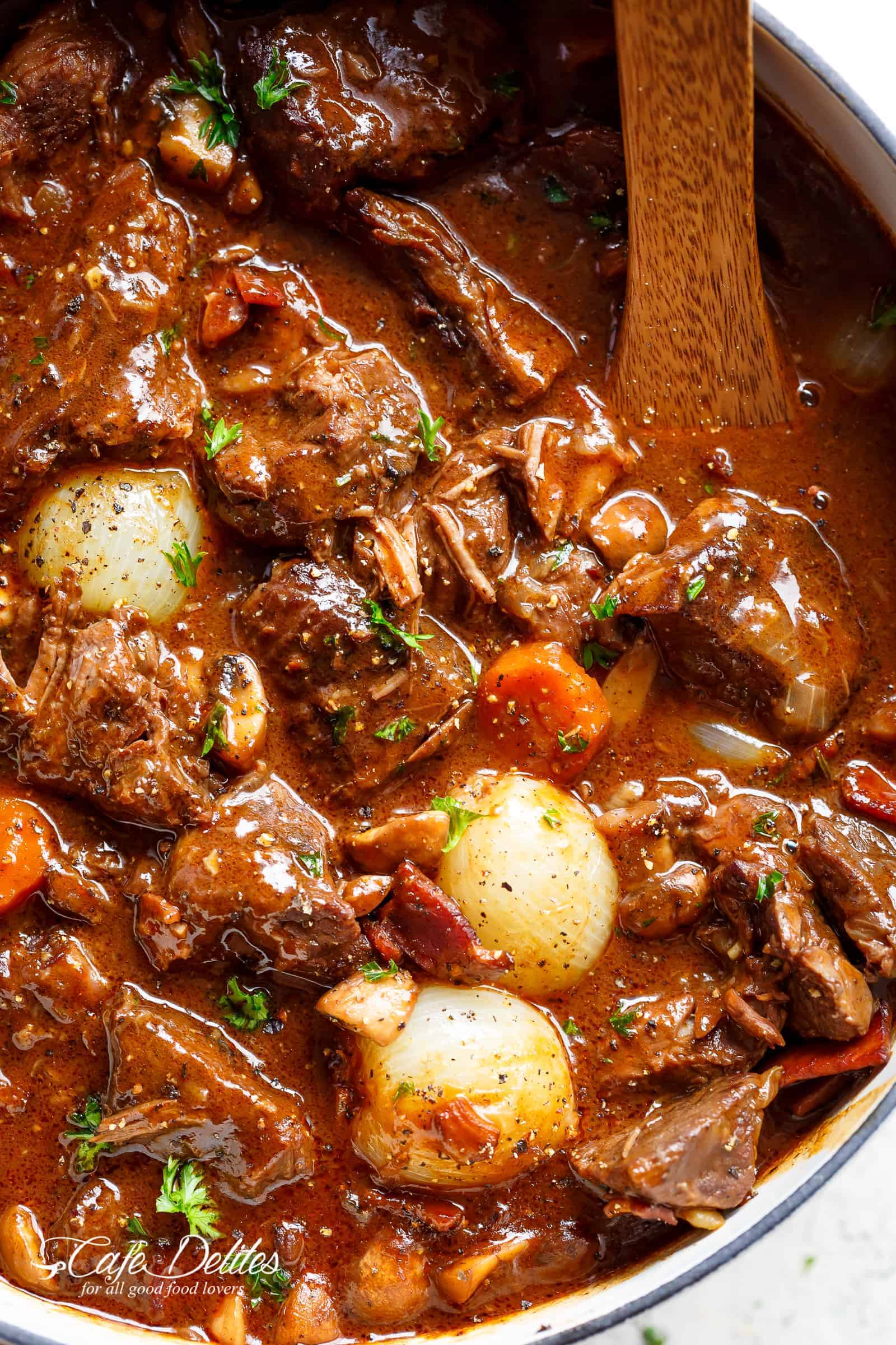 Tender fall apart chunks of beef simmered in a rich red wine gravy makes Julia Child's Beef Bourguignon an incredible family dinner. Slow Cooker, Instant Pot/Pressure Cooker, Stove Top and the traditional Oven method included! Easy to make, every step is worth it | cafedelites.com