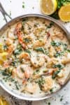 Creamy Garlic Butter Shrimp Piccata is the recipe of your dreams! Garlic butter shrimp coated in a rustic creamy garlic parmesan sauce with a hint of lemon, capers and spinach! | cafedelites.com