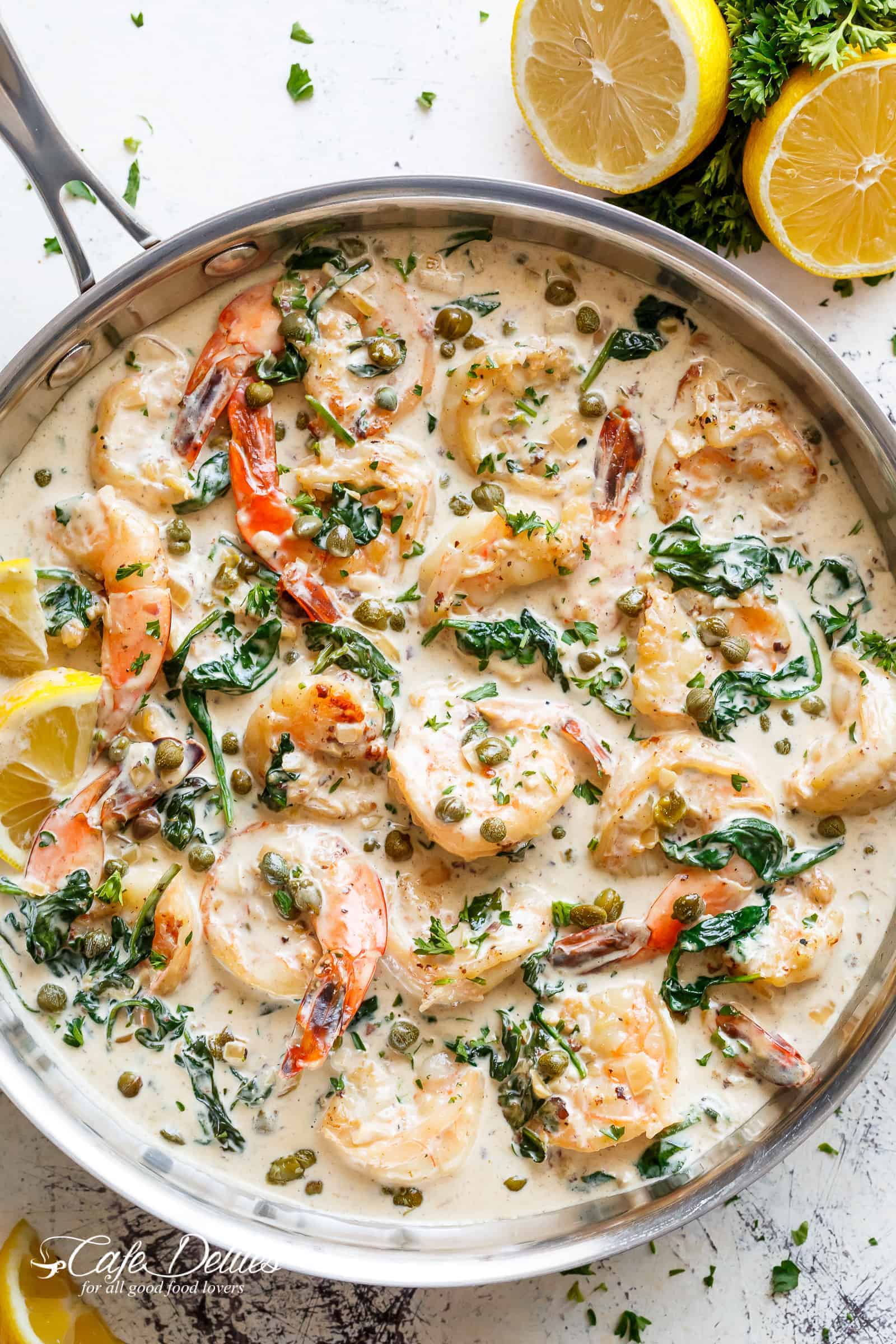 Creamy Garlic Butter Shrimp Piccata is the recipe of your dreams! Garlic butter shrimp coated in a rustic creamy garlic parmesan sauce with a hint of lemon, capers and spinach! | cafedelites.com