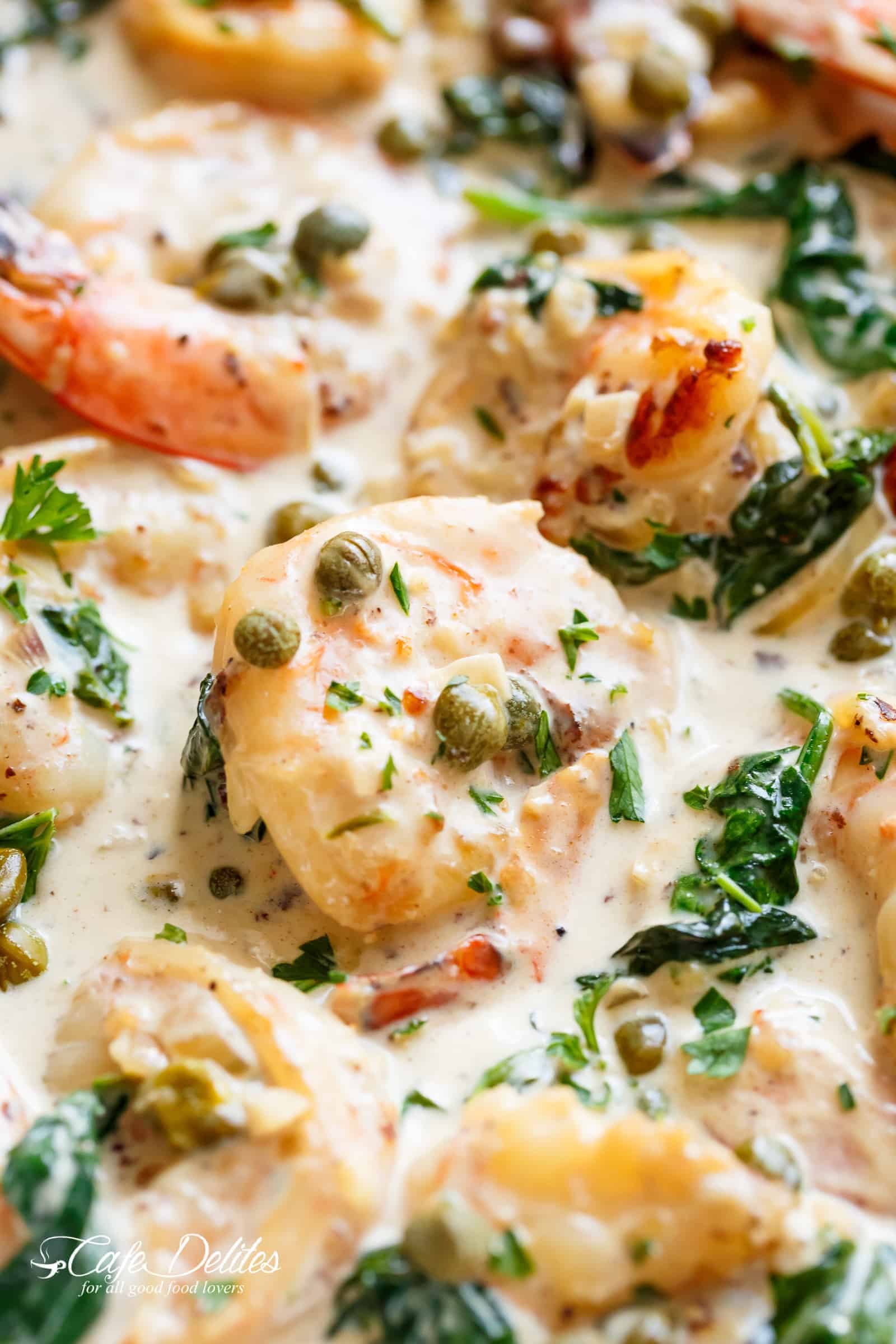Creamy Garlic Butter Shrimp Piccata is the recipe of your dreams! Garlic butter shrimp coated in a rustic creamy garlic parmesan sauce with a hint of lemon, capers and spinach! Leave people wondering if there is a hidden chef in your kitchen! Quick and easy to make, ready on the table in less than 15 minutes! | cafedelites.com