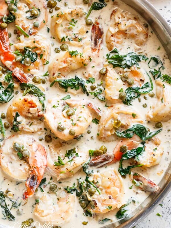 Top view image of Garlic butter shrimp coated in a rustic creamy garlic parmesan sauce with a hint of lemon, capers and spinach!