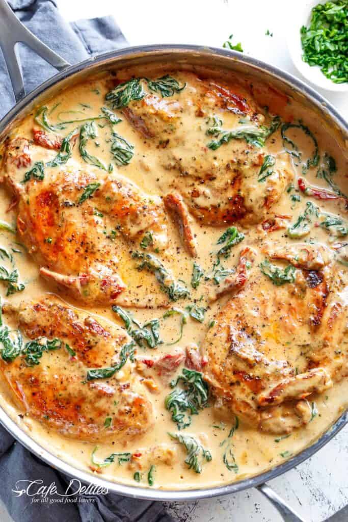 Creamy Tuscan Chicken with parmesan spinach sauce in a pan