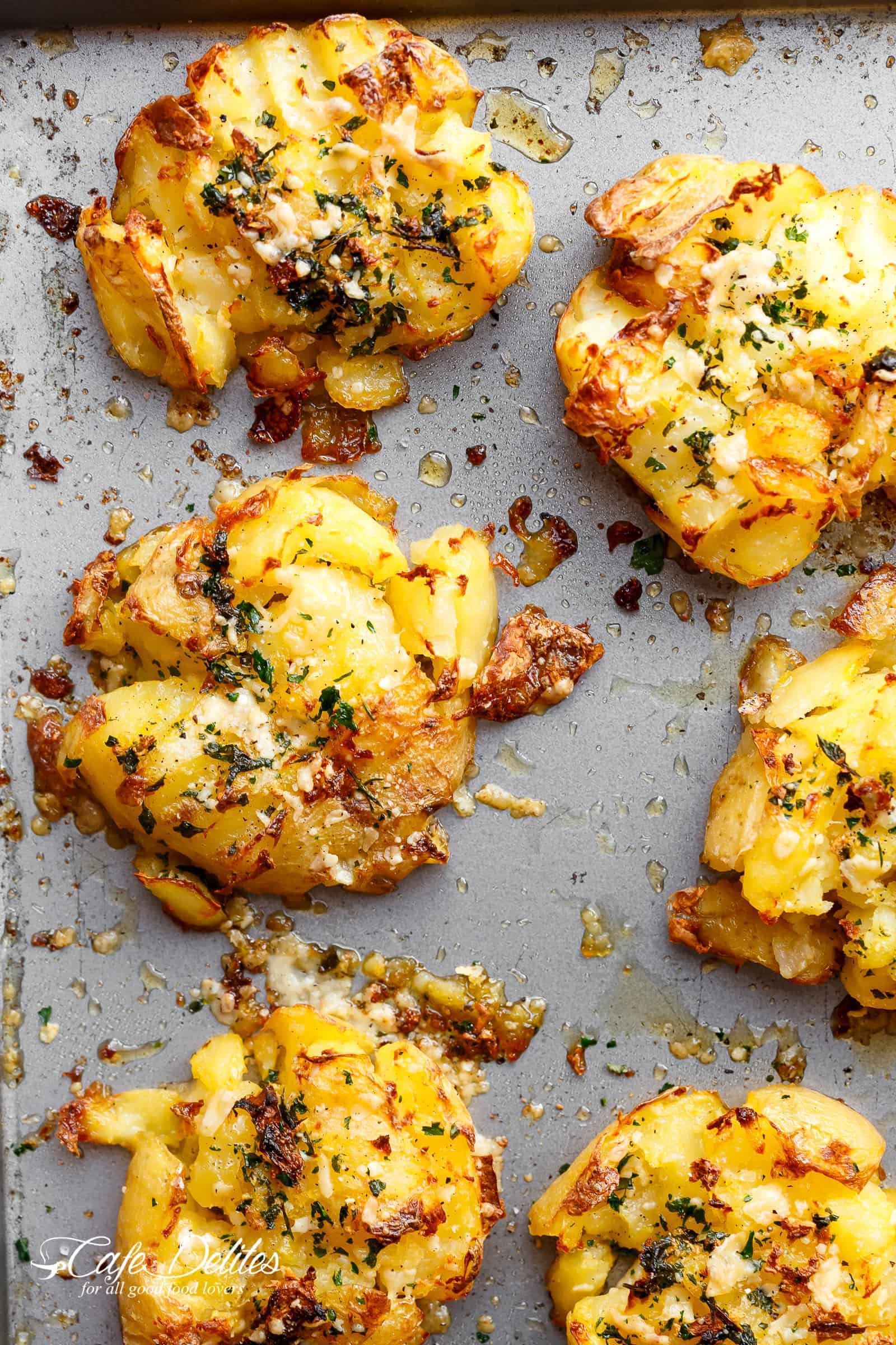 Crispy Garlic Butter Parmesan Smashed Potatoes are just like buttery and garlicky French fries or crispy hot chips. | http://cafedelites.com