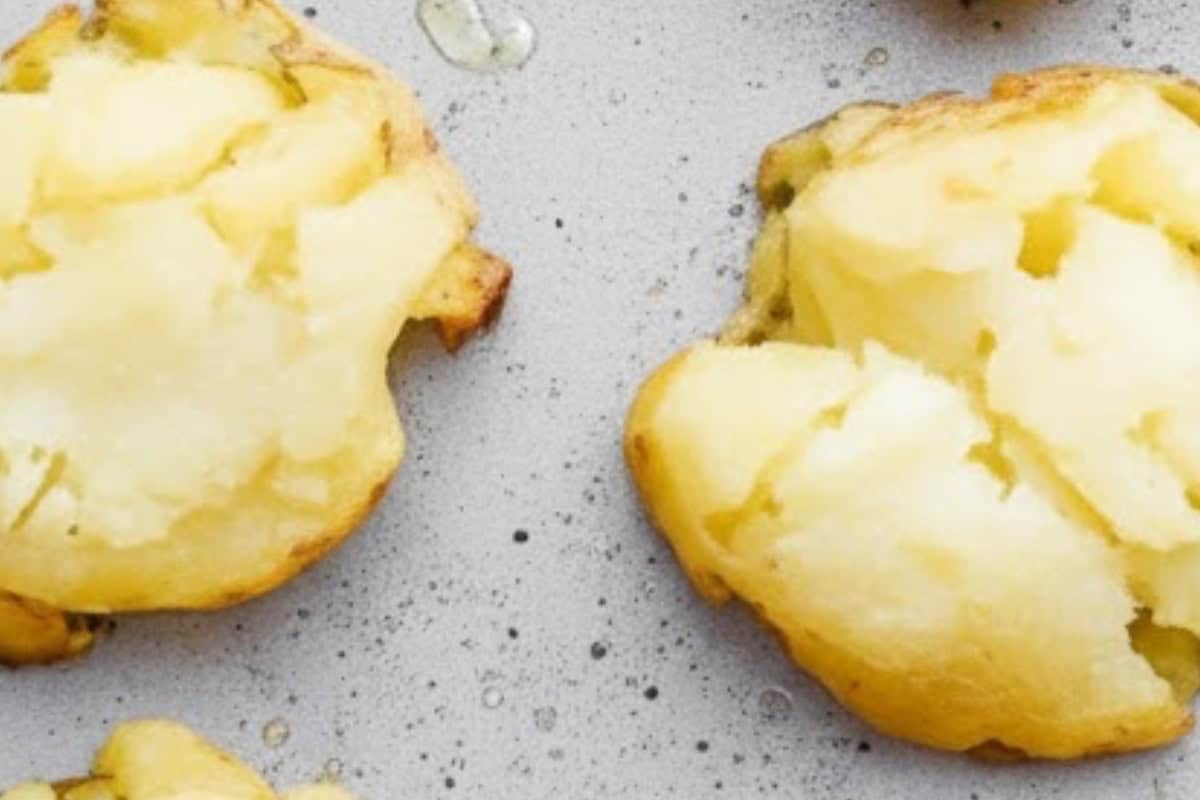 Arrange the boiled potatoes on the prepared baking sheet and smash using a potato masher