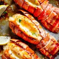 Broiled Lobster Tails with Honey Garlic Butter White Wine Sauce is a fancy, classy and best of all EASY to make recipe. Ready in under 20 minutes, let the oven do all the cooking for you! Full of flavour, there's no need to go to a restaurant for chef-tasting, slightly charred lobster tails! | cafedelites.com