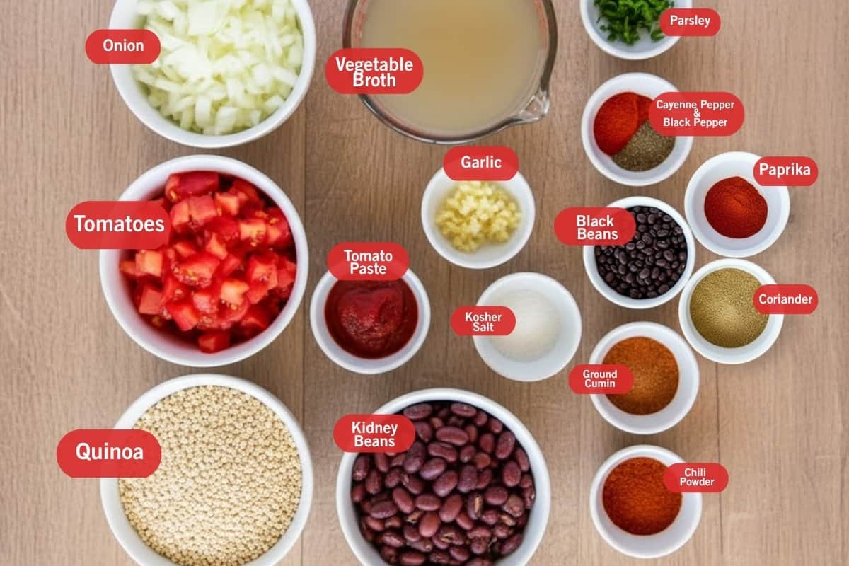 Flat lay photo of ingredient shot of onion, vegetable broth, parsley, cayenne pepper and black pepper, paprika, coriander, black beans, ground cumin, chili powder, kidney beans, kosher salt, tomato paste, garlic, diced tomatoes, quinoa