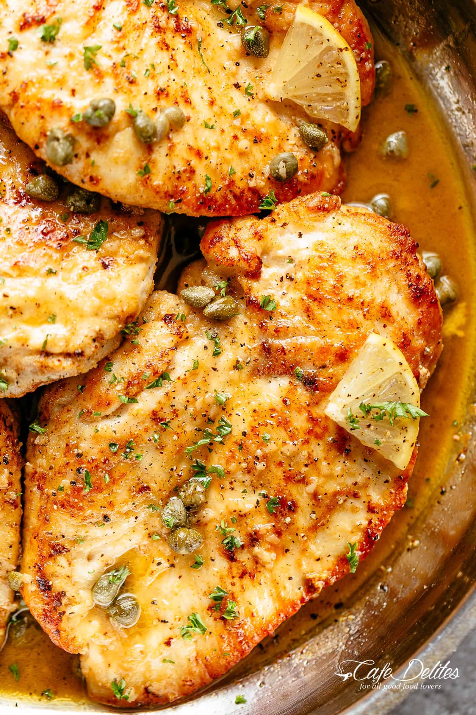 Chicken Piccata in a buttery, silky, lemon garlic sauce with capers and white wine or stock! | cafedelites.com