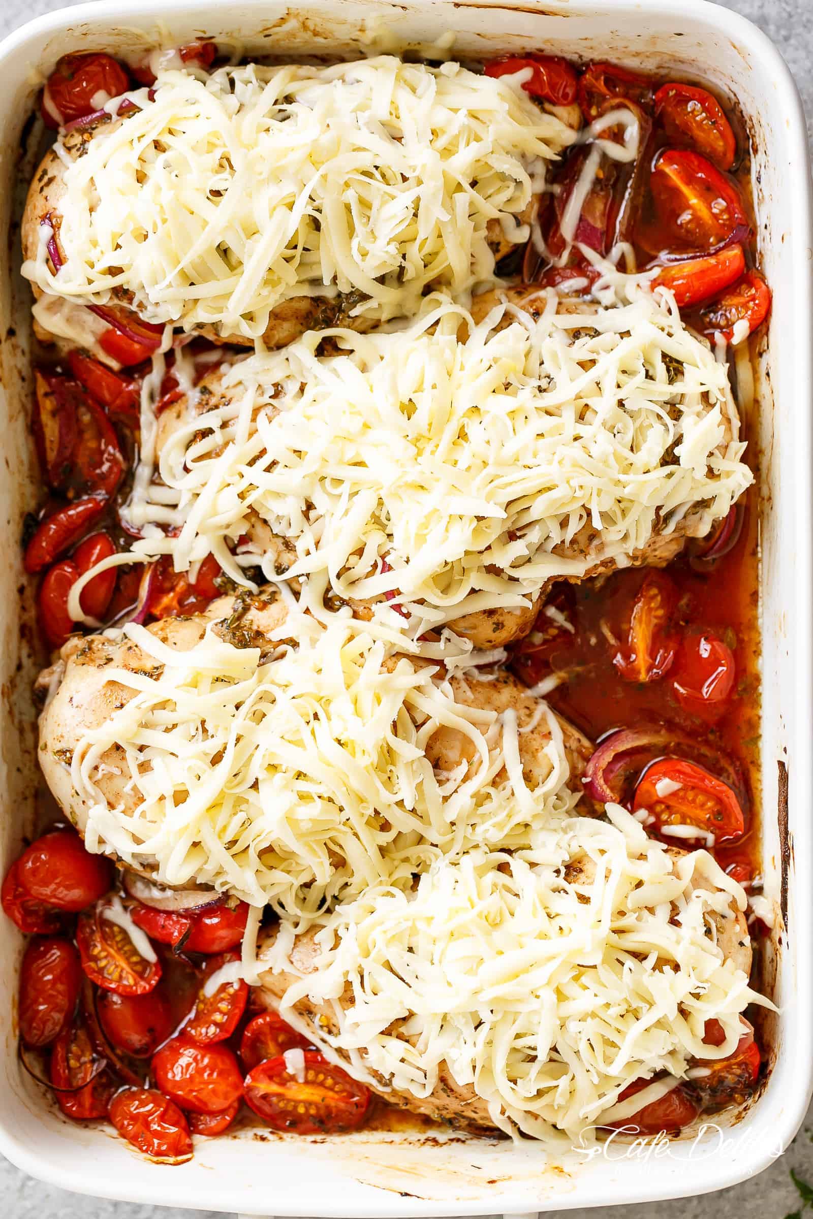 Balsamic Baked Chicken Breast rubbed with garlic and herbs, dripping with a tomato balsamic sauce and melted mozzarella cheese! EASY chicken recipe! | https://cafedelites.com