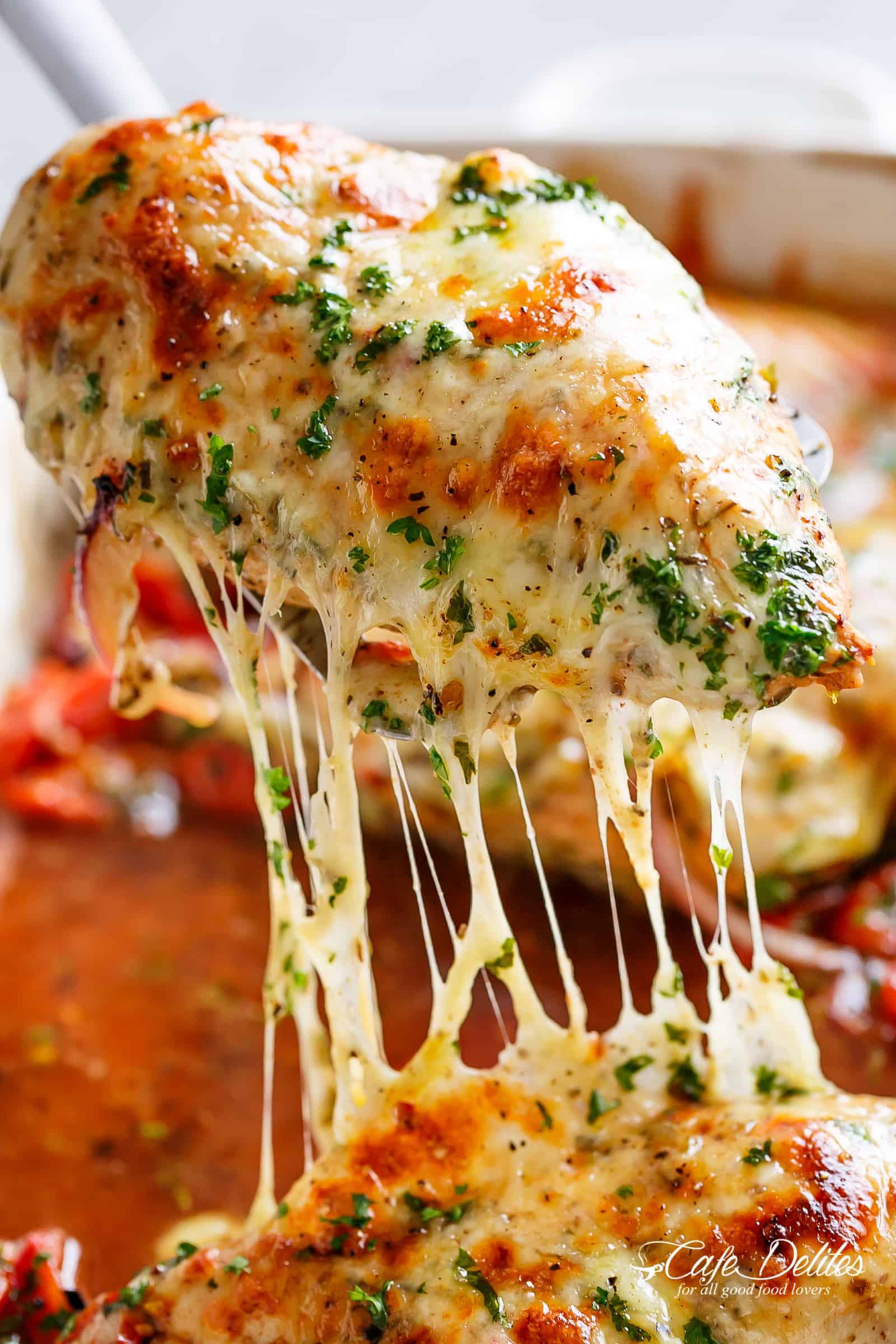 Balsamic Baked Chicken Breast rubbed with garlic and herbs, dripping with a tomato balsamic sauce and melted mozzarella cheese! | https://cafedelites.com