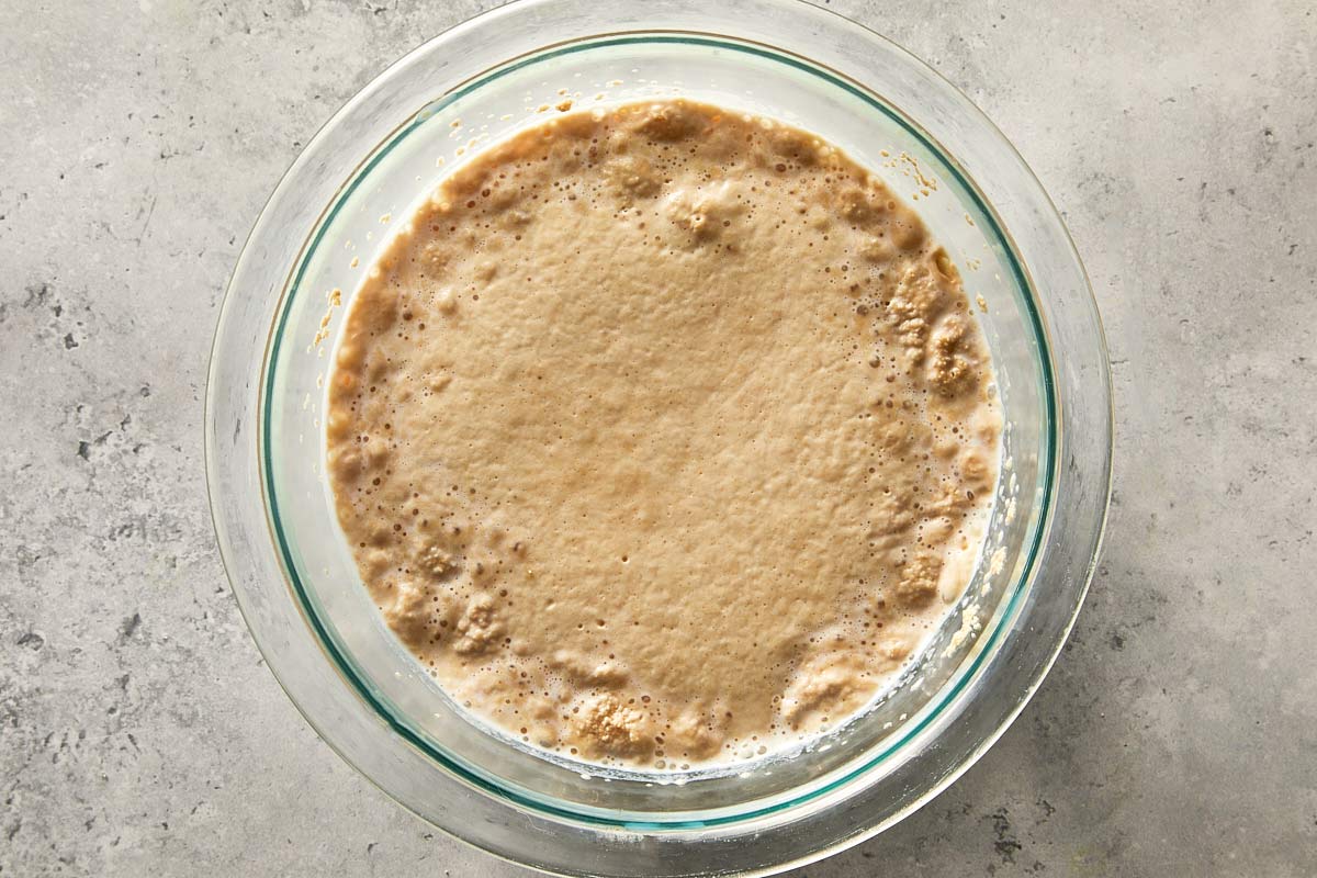 yeast activating in warm milk with bubbles forming on top