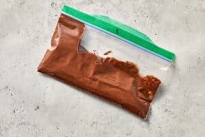 piping chocolate crosses on buns