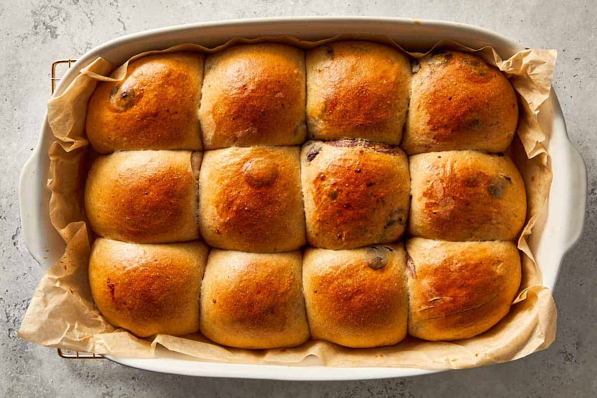 shaped dough balls rising in baking tray after baking
