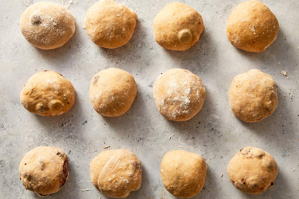 dough divided and shaped into balls arranged in baking tray