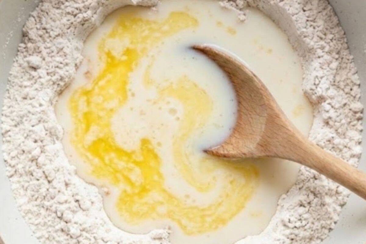 Make a well in the centre, add the warm milk and melted butter, stir together, add the egg