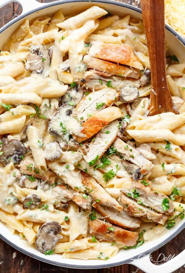 Creamy Garlic Parmesan Chicken Alfredo is all cooked in ONE POT! Ready and on the table in less than 20 minutes! Seared chicken is mixed through a super creamy garlic parmesan flavoured pasta with white wine and mushrooms! A favourite Chicken Alfredo recipe! | cafedelites.com