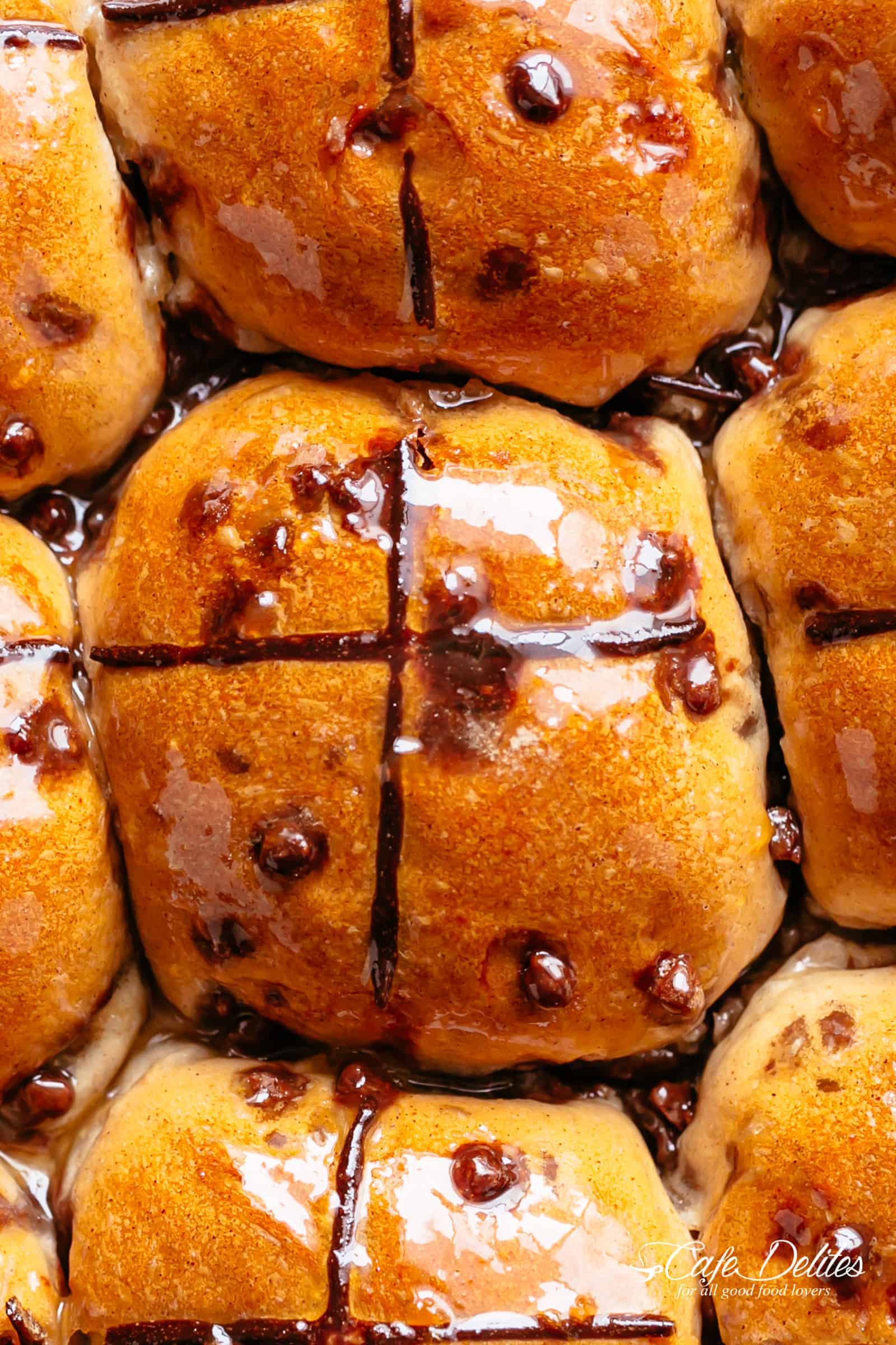 Fluffy and fragrant homemade hot cross buns filled with melted chocolate chips are better than store bought! | cafedelites.com