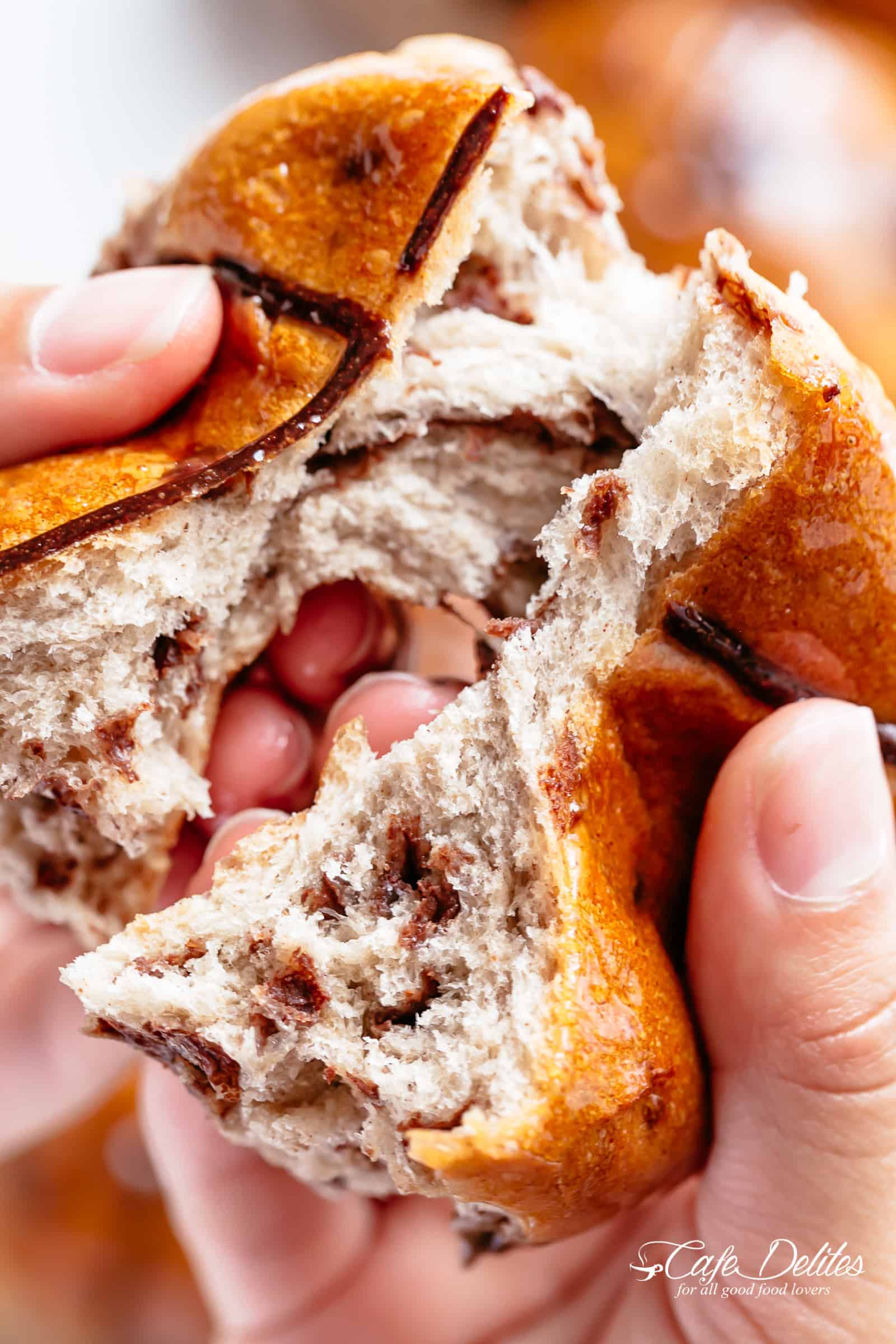 Fluffy and fragrant homemade hot cross buns filled with melted chocolate chips to please the kids as well as the adults! | cafedelites.com