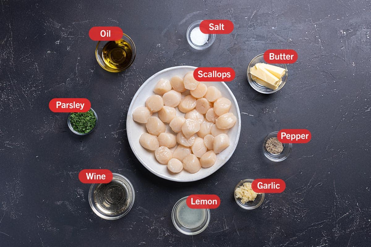 Image of the ingredients required to prepare this recipe, specifically: Scallops, Lemon, Wine, Parsley, Oil, Salt, Butter, Pepper, and Garlic