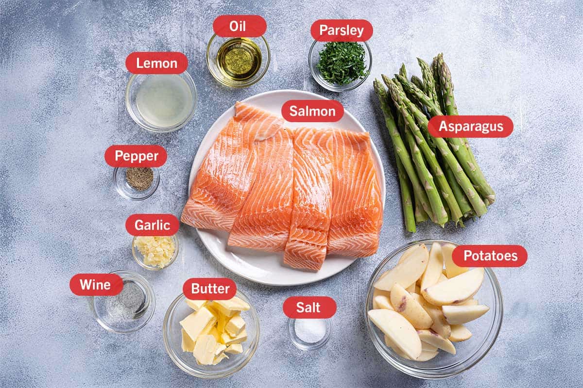 Ingredients needed for Garlic Butter Baked Salmon, specifically: lemon, oil, parsley, asparagi, potatoes, salt, butter, wine, garlic, and pepper.