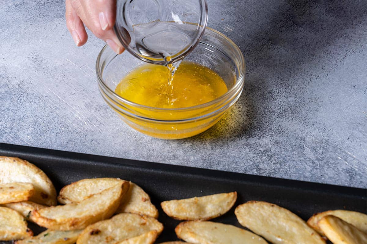 Butter, lemon juice, and wine being mixed together in a small bowl.