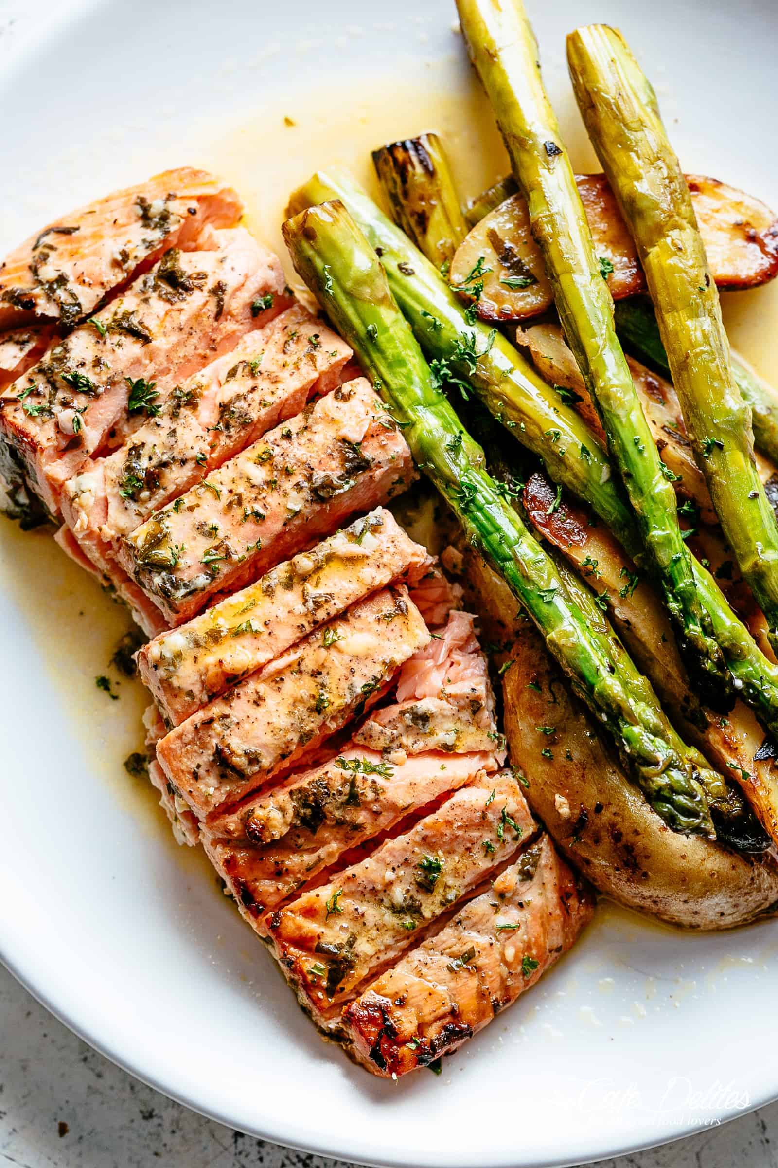 Sheet Pan Garlic Butter Baked Salmon with crispy potatoes, asparagus and a garlic butter sauce with a touch of lemon | cafedelites.com