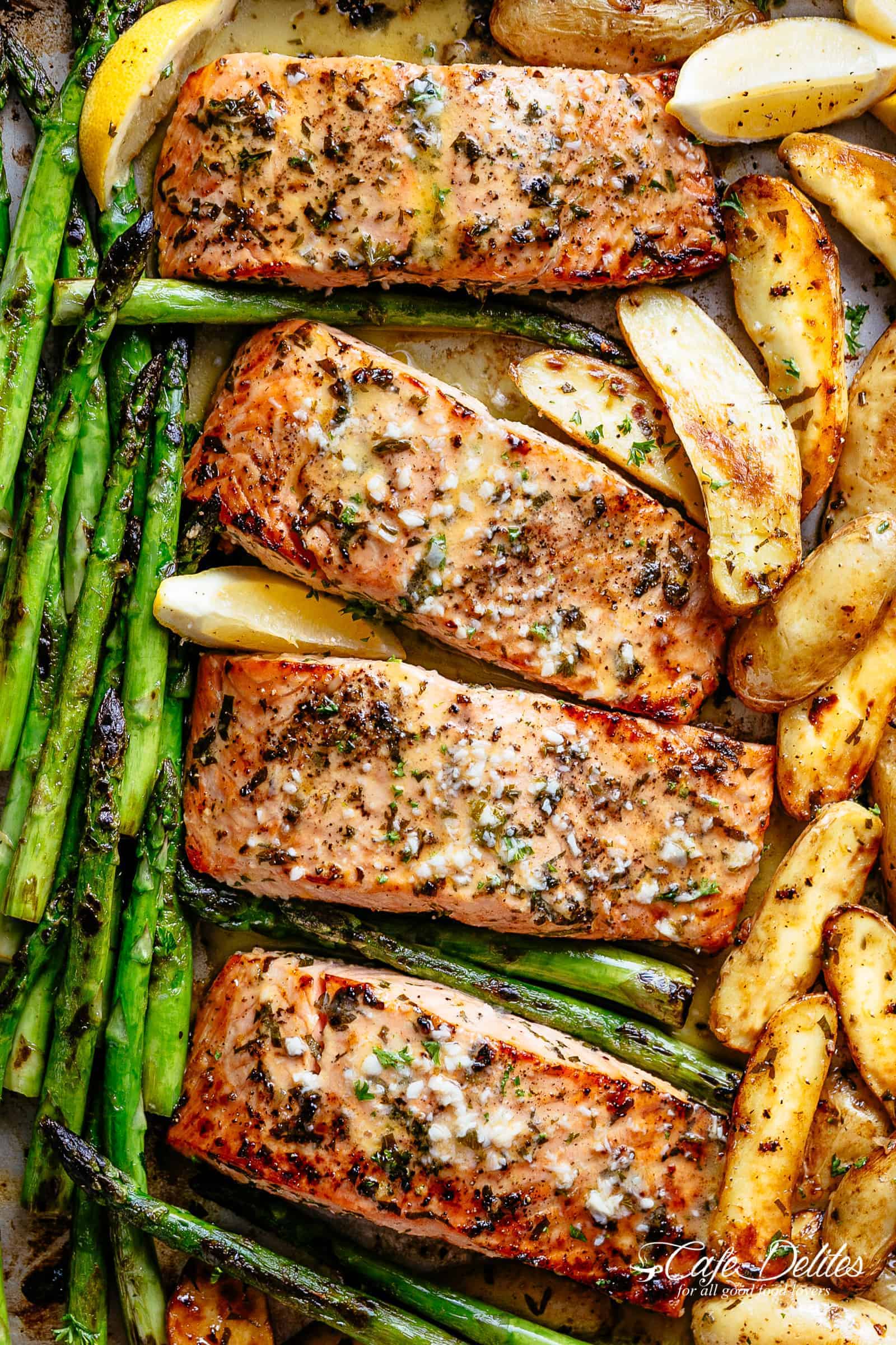 Sheet Pan Garlic Butter Baked Salmon with crispy potatoes, asparagus and a garlic butter sauce with a touch of lemon | cafedelites.com