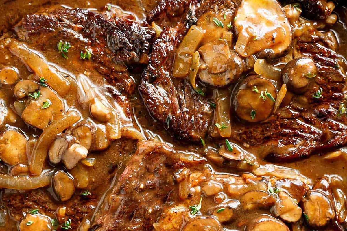 Close-up shot of Steaks With Mushroom Gravy.