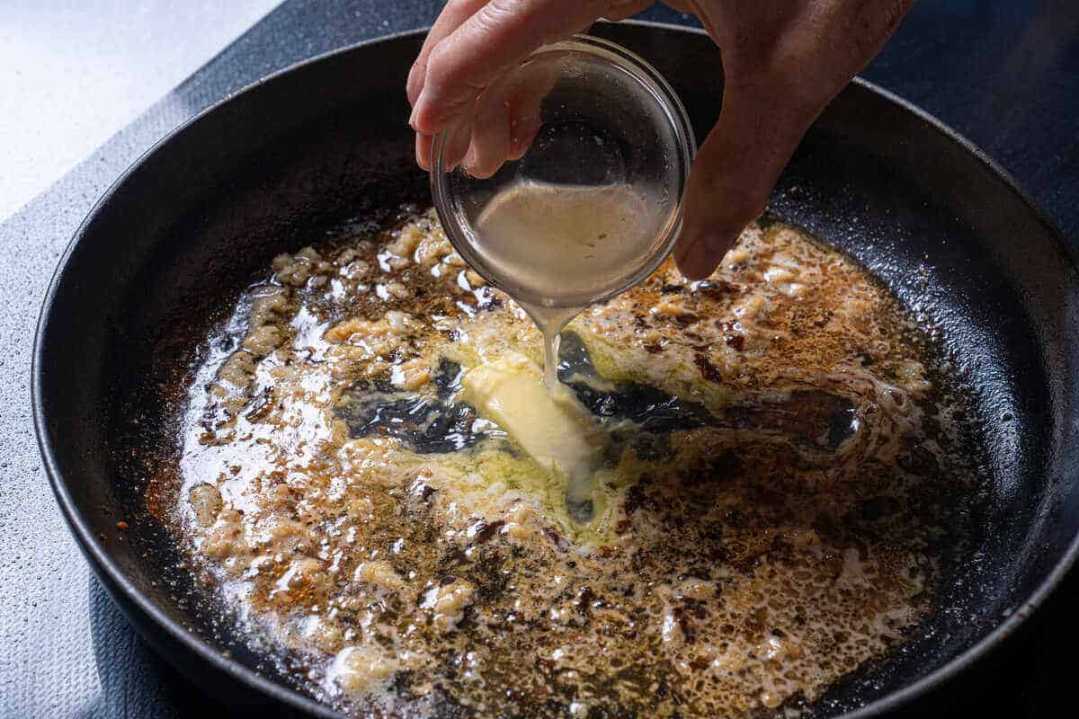 An image of butter melting together with garlic.