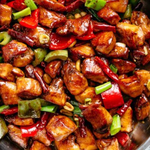 Kung Pao Chicken is highly addictive stir-fried chicken with the perfect combination of salty, sweet and spicy flavour! Make it better than Chinese take out right at home! With crisp-tender chicken pieces and some crunchy veggies thrown in, this is one Kung Pao chicken recipe hard to pass up