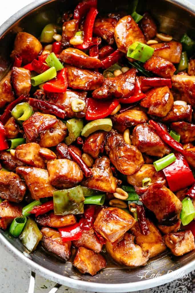 Kung Pao Chicken is highly addictive stir-fried chicken with the perfect combination of salty, sweet and spicy flavour! Make it better than Chinese take out right at home! With crisp-tender chicken pieces and some crunchy veggies thrown in, this is one Kung Pao chicken recipe hard to pass up!  | cafedelites.com
