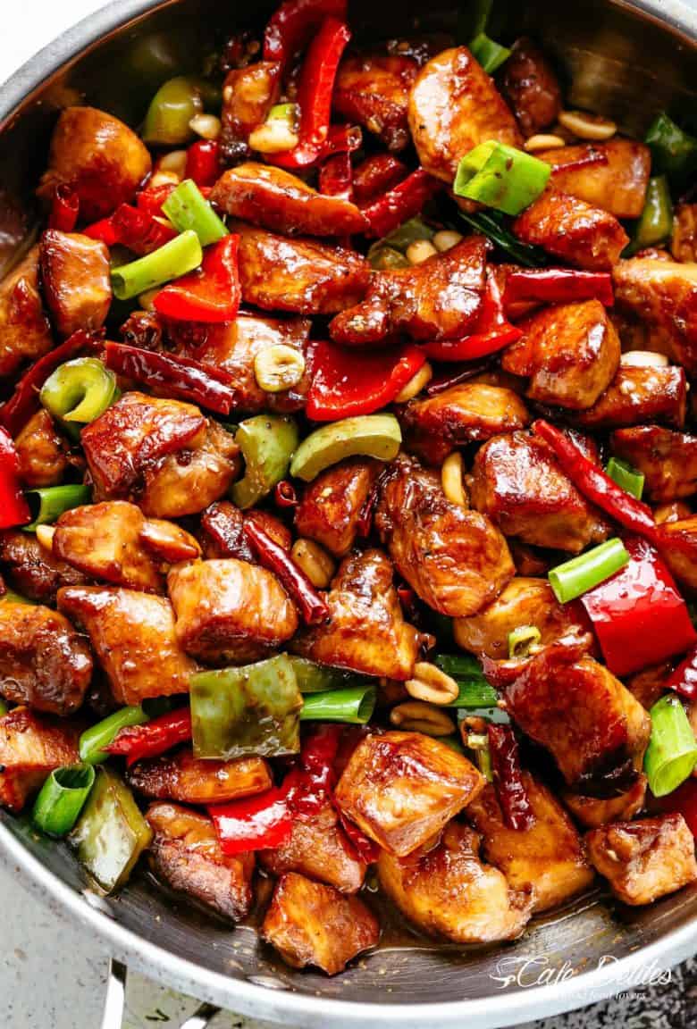 Kung Pao Chicken is highly addictive stir-fried chicken with the perfect combination of salty, sweet and spicy flavour! Make it better than Chinese take out right at home! With crisp-tender chicken pieces and some crunchy veggies thrown in, this is one Kung Pao chicken recipe hard to pass up!  | cafedelites.com