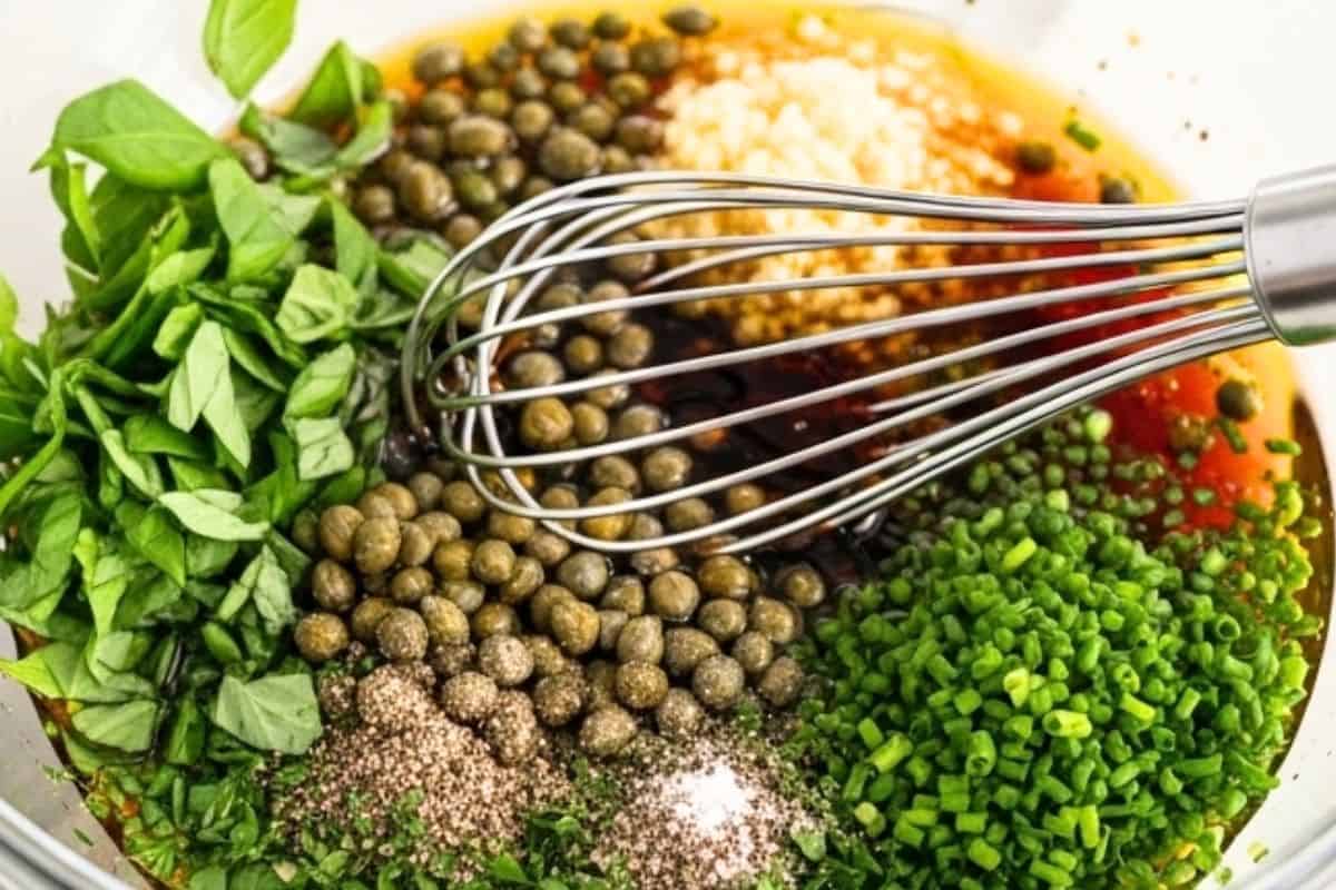 In a large bowl, whisk all the dressings.