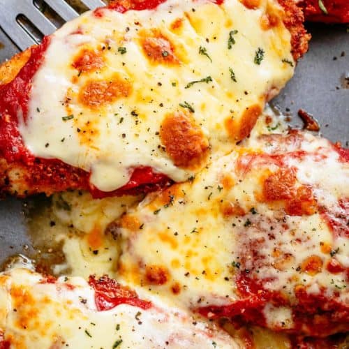 The Best Chicken Parmesan with a deliciously crispy breadcrumb coating, smothered in a rich homemade tomato sauce and melted mozzarella cheese! This is here best Chicken Parmesan you will ever make! Simple to make and worth every minute. If you love a crispy crumb coating vs soggy crumb, look no further!