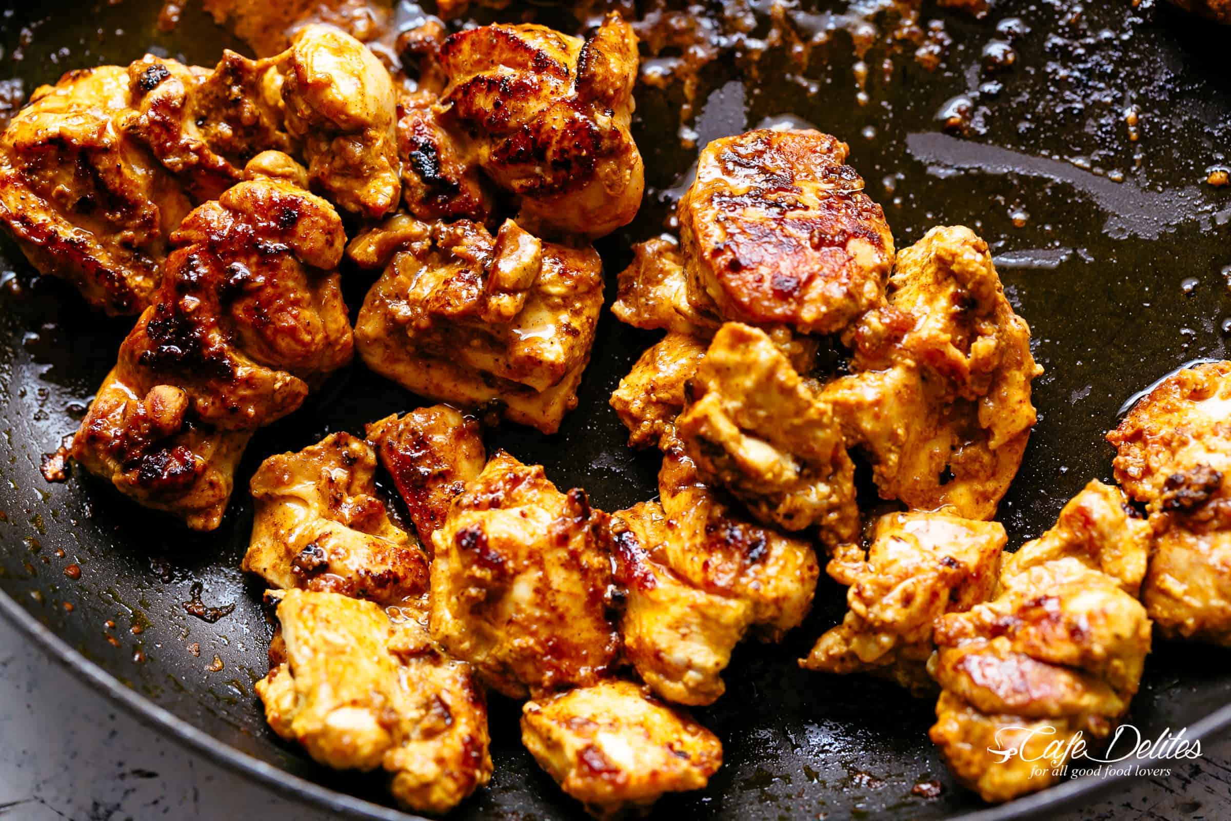 frying of  Chicken Tikka Masala in a black skillet