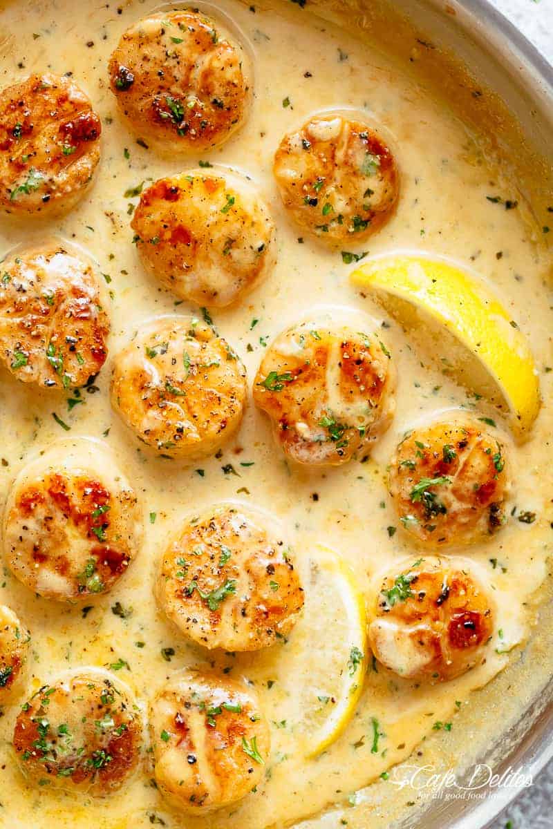 Creamy Garlic Scallops are just as good as restaurant scallops with minimal ingredients and maximum flavour! A silky, creamy garlic sauce with a hint of lemon coats crispy, buttery scallops! With only a handful of ingredients, you're minutes away from having the most incredible scallops on your dinner table! | cafedelites.com