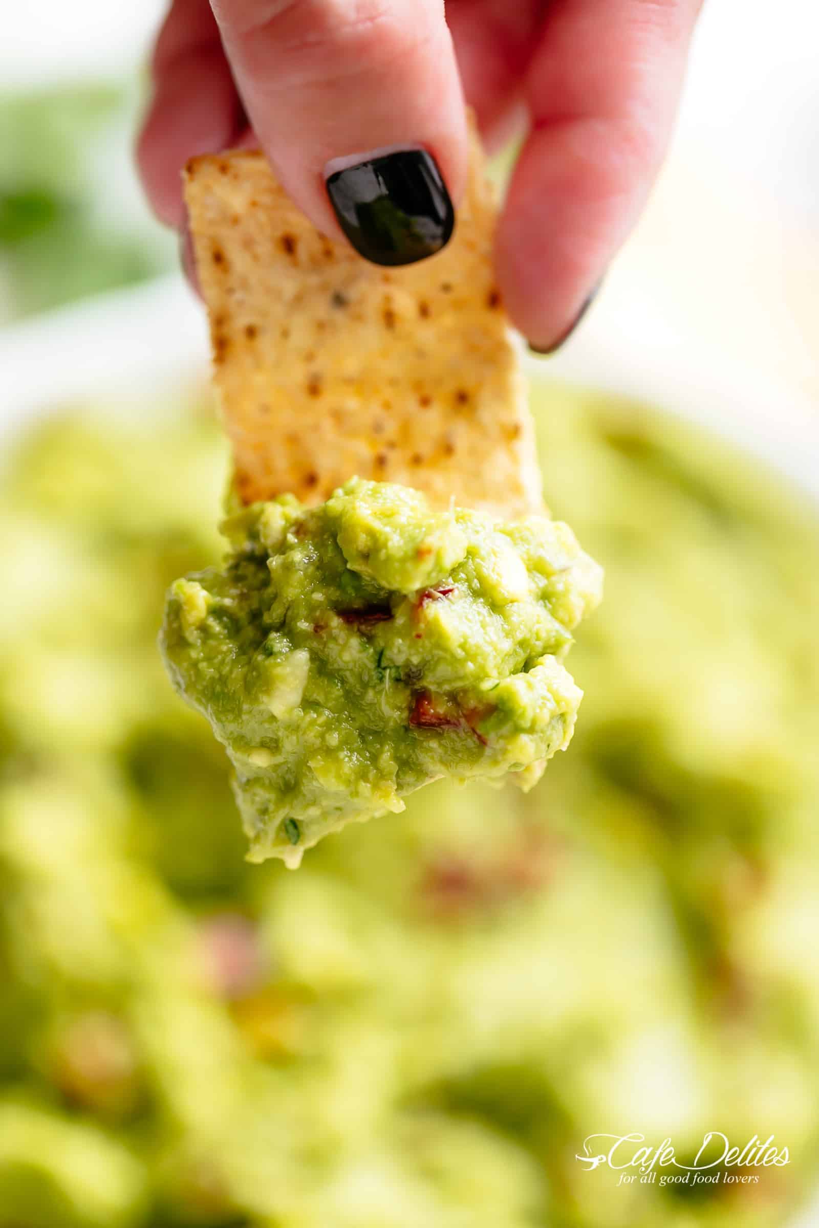 The best, creamy Guacamole is so easy to make and better than anything found in a jar! Homemade Guacamole takes minutes to make and is so incredibly delicious! Perfect for a party as an appetizer OR just a simple snack! Use as a topping for your favourite fajitas, tacos and even carnitas! | cafedelites.com