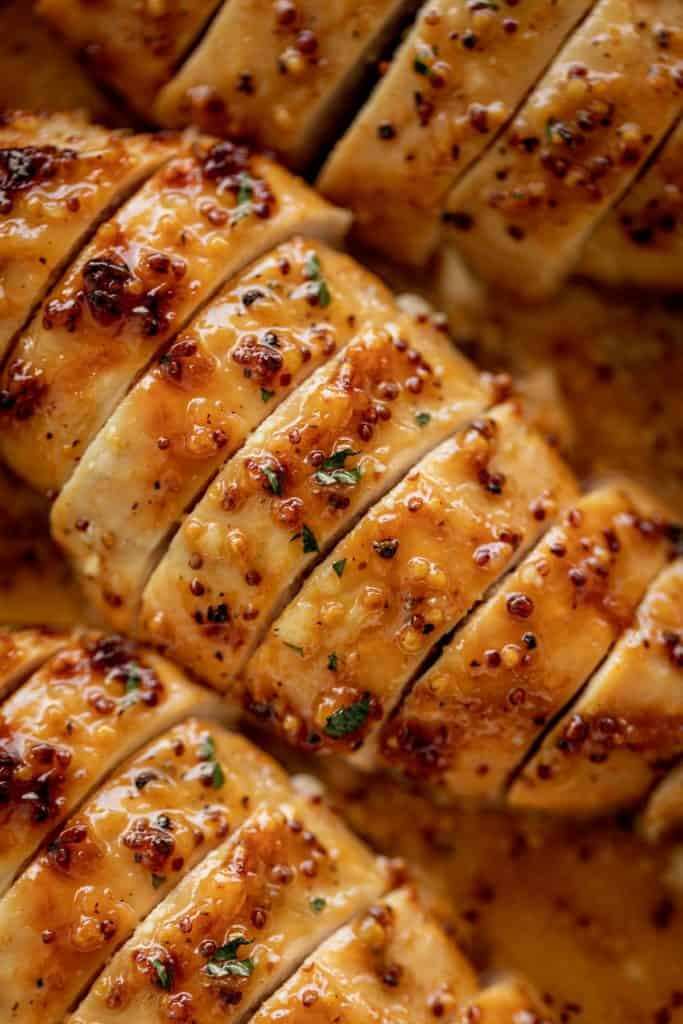 Tender and juicy Baked Chicken Breasts with a delicious honey mustard sauce with a kick of garlic and lemon juice takes only minutes to make! Baked Chicken couldn't be any easier to prepare for a quick and easy dinner idea! This will become your new favourite chicken breast recipe. | cafedelites.com