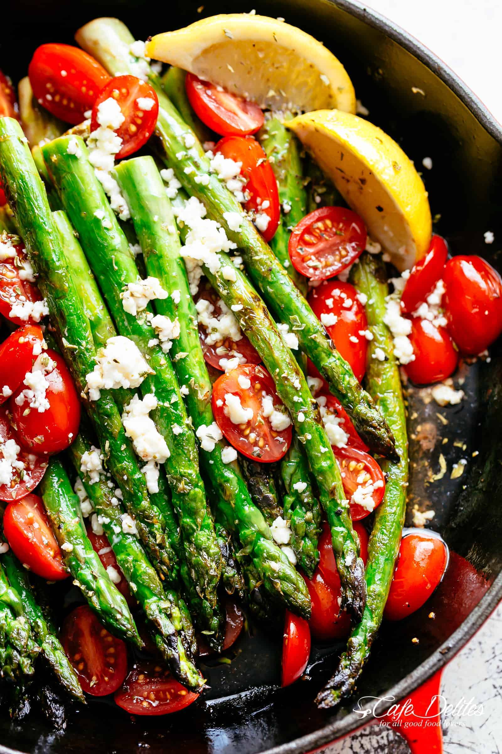 Lemon Garlic Asparagus topped feta cheese, tomatoes and drizzled with Mediterranean flavours makes the perfect side dish! Extremely addictive and takes less than 10 minutes to cook! Crispy on the outside, nice and tender on the inside and full of incredible lemon, garlic and herb flavours! | cafedelites.com
