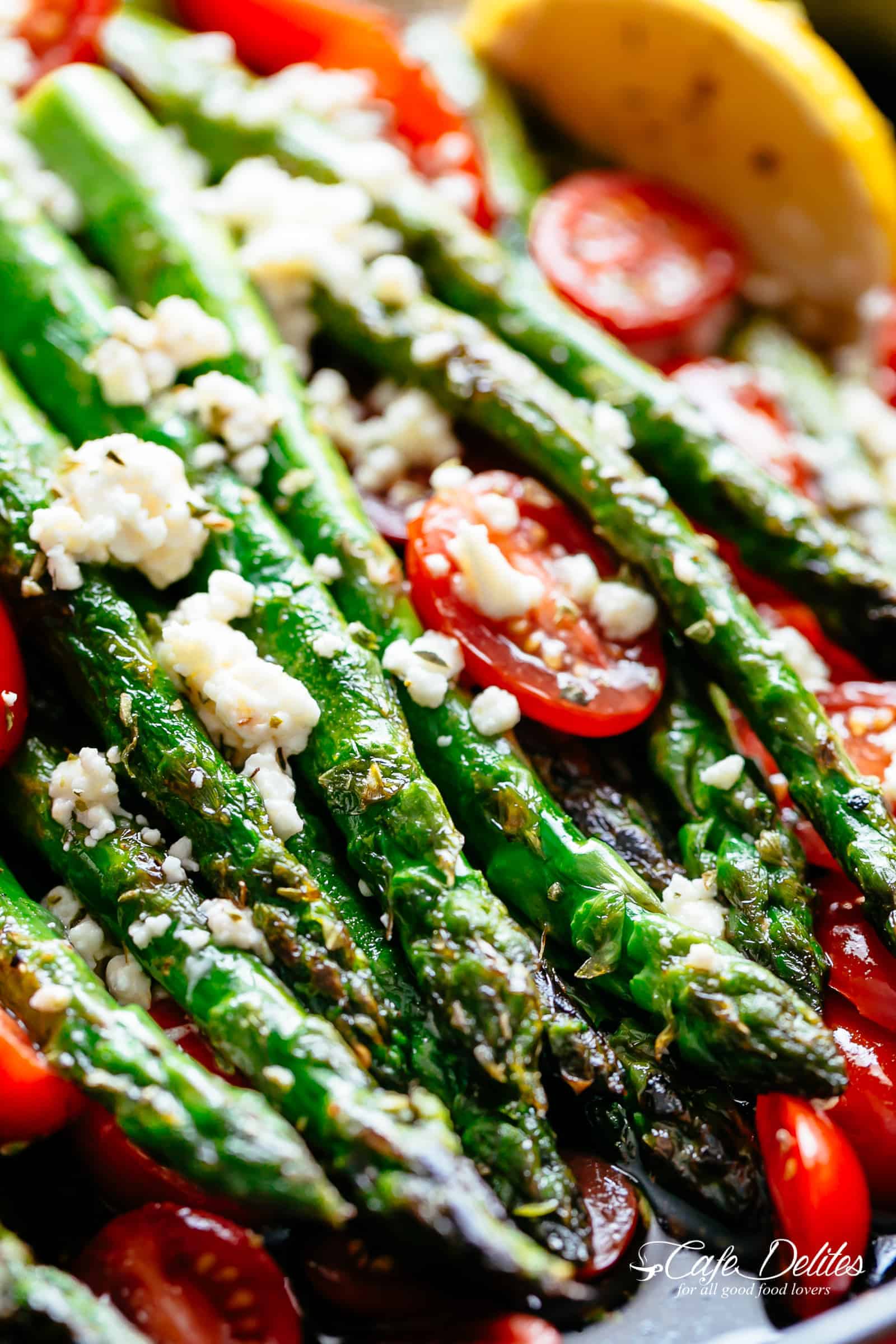 Lemon Garlic Asparagus topped feta cheese, tomatoes and drizzled with Mediterranean flavours makes the perfect side dish! | cafedelites.com