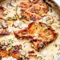 Seared Pork Chops with a creamy garlic and herb mushroom sauce is a super easy dinner recipe! Perfect for any night of the week! The ultimate ONE PAN Pork Chop Recipe is ready on the table in less than 20 minutes! | cafedelites.com