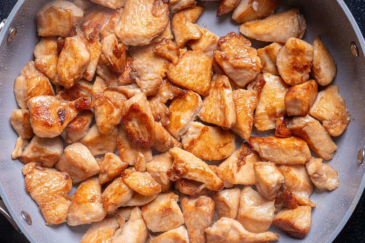 diced chicken seared in a pan
