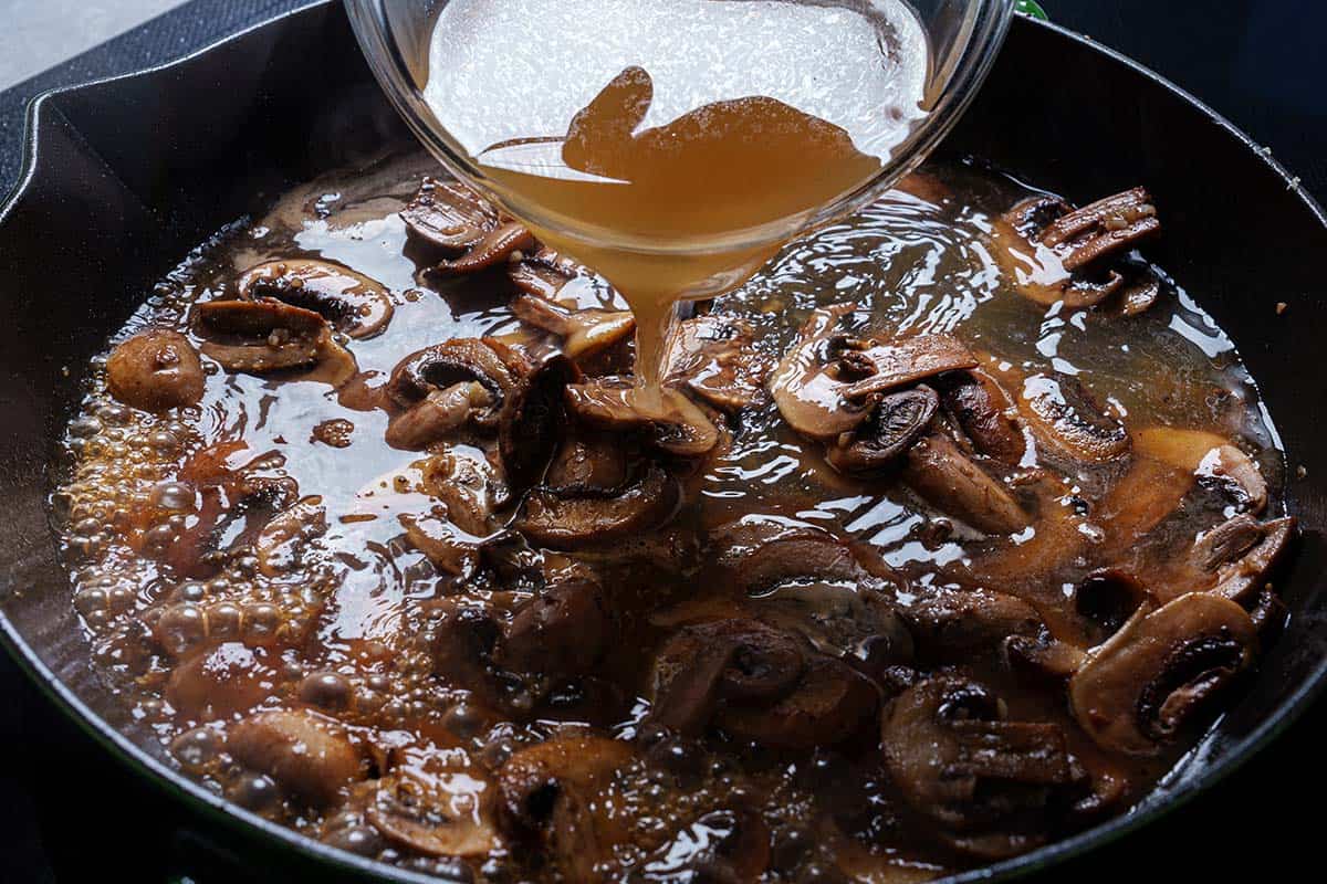 An image of stock being added to the mushrooms.