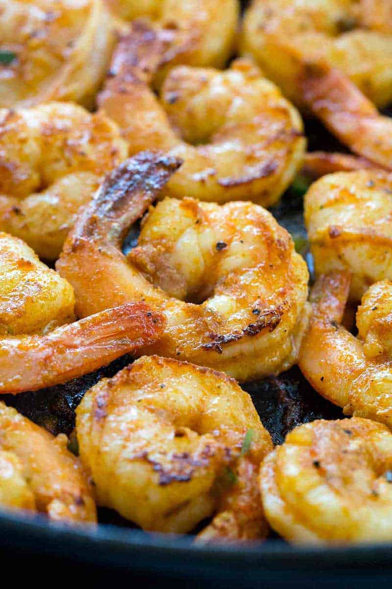 Shrimp cooking in a cast iron skillet