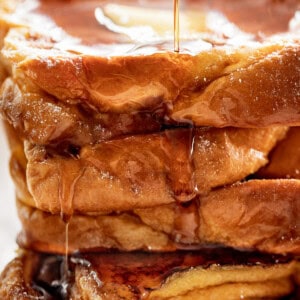 Side view image of The Best French Toast drizzled with maple syrup.