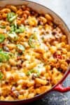 Chili Mac and Cheese with beans is the ultimate mash up of TWO favourites -- Chili PLUS Mac and Cheese! Using leftover chili OR chili made from scratch, this casserole is ready and on the table in less than 30 minutes! Incredible flavours that the whole family will go crazy for! | cafedelites.com